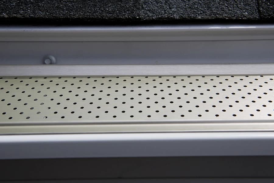 Close-up of an installed perforated aluminum gutter guard